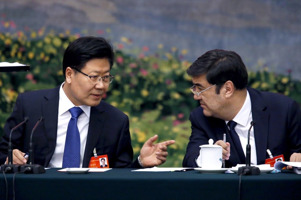 Xinjiang party secretary Zhang Chunxian (left), a Han Chinese, and Xinjiang's Uygur governor, Nur Bekri. Delegates at the meeting on Thursday mostly avoided talking about ethnic unrest in the region. Photo: Reuters