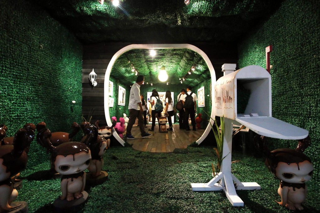 Visitors to Art Fair Philippines view a piece by Gene Paul Martin entitled Sleep Walker. Photos: EPA, Art Fair Philippines, John Batten