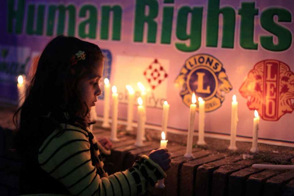 A girl lights candles during a rally to commemorate International Women's Day in Islamabad. Photo: Reuters