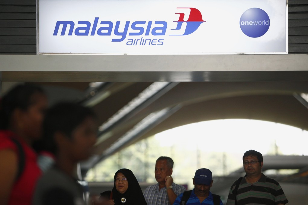 People walk under a Malaysia Airlines sign at Kuala Lumpur International Airport in Sepang. Photo: Reuters