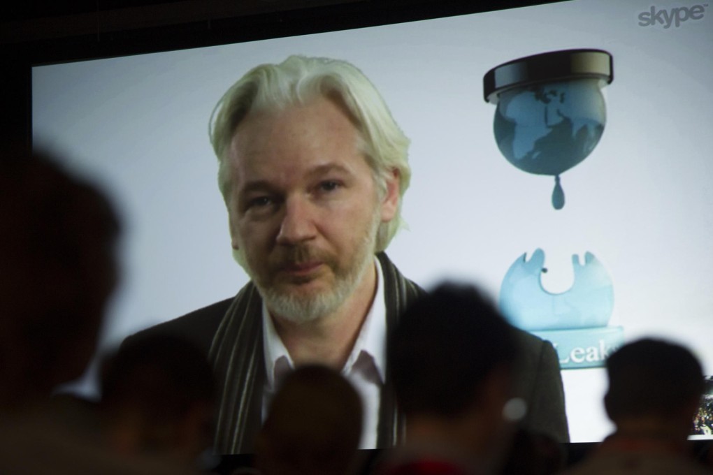 Attendees watch Assange from Austin, Texas. Photo: Bloomberg