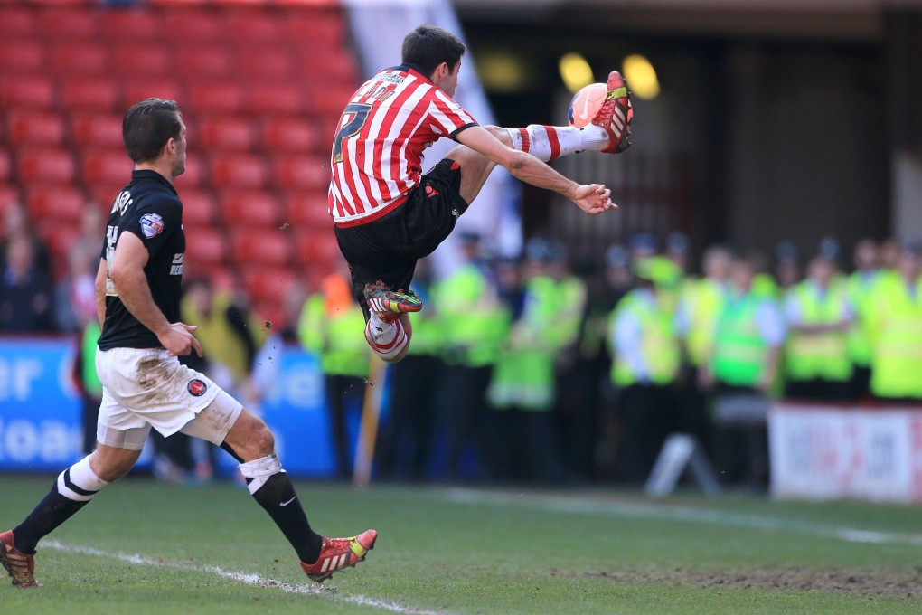 Ryan Flynn scores Sheffield's first goal of the game against Charlton Athletic at Bramall Lane. Photo: AP