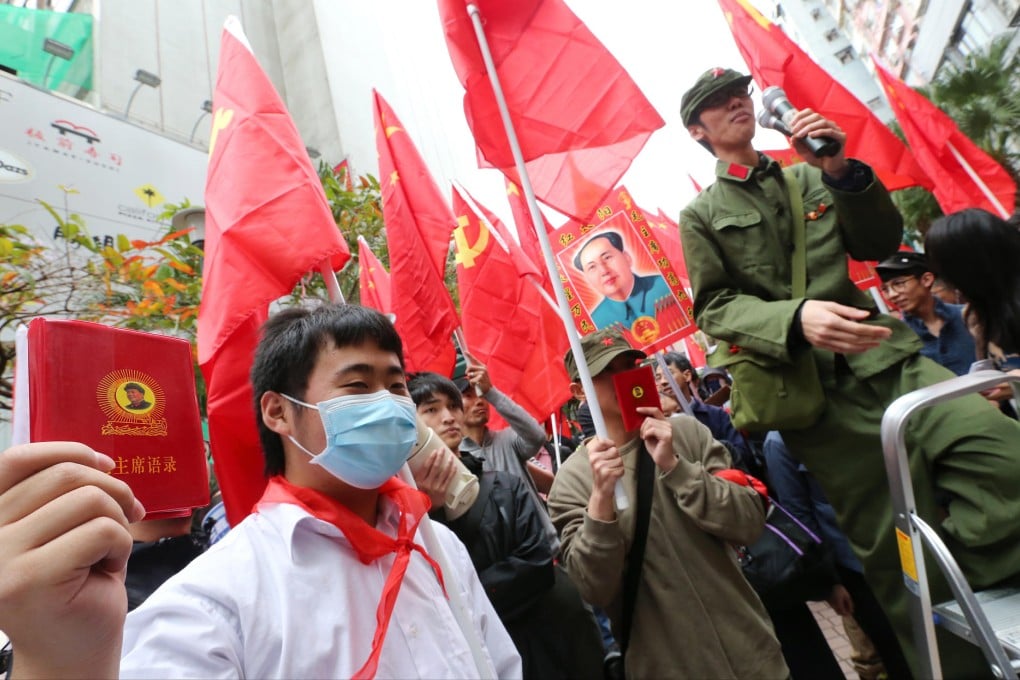 A protester displays a book of Mao's quotations during the march through Mong Kok yesterday. Photo: David Wong