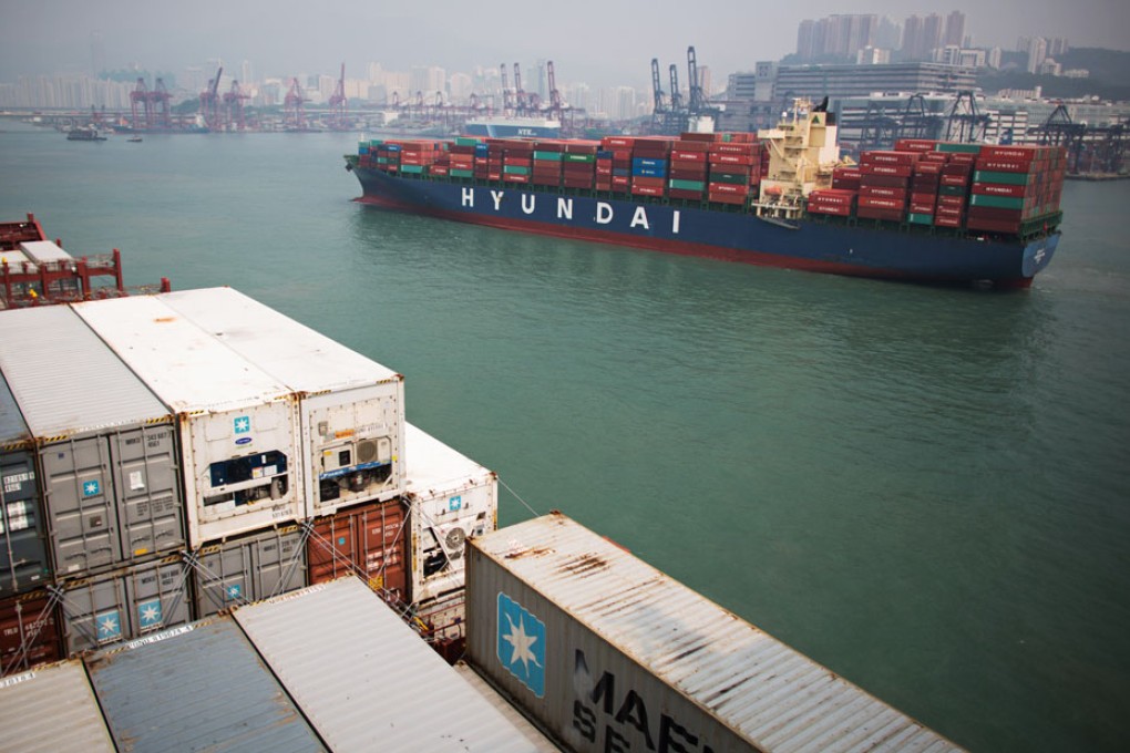 Containers are stacked aboard cargo ships in Hong Kong. Photo: Bloomberg