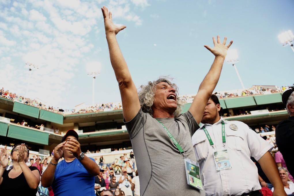 Sergio Giorgi (centre), father and coach of Camila Giorgi of Italy, celebrates his daughter's victory over Maria Sharapova. Photo: EPA