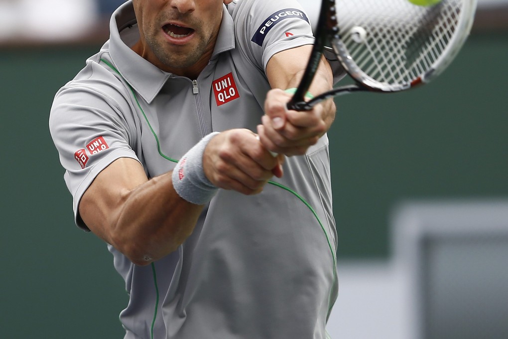 Novak Djokovic hits a return against Alejandro Gonzalez of Columbia. Photo: EPA