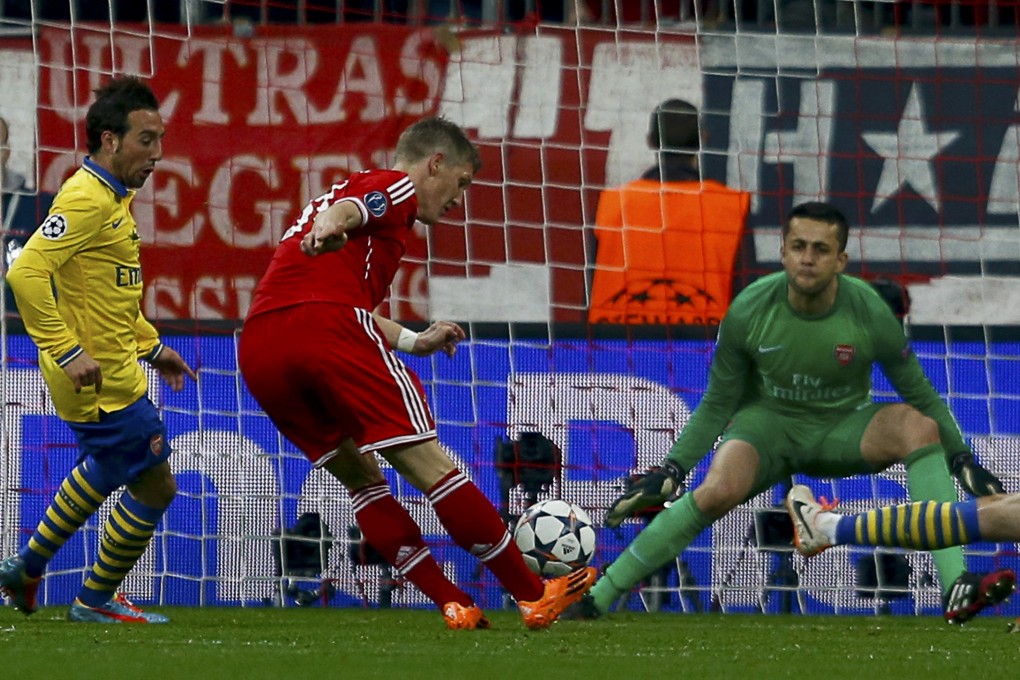 Bayern's Bastian Schweinsteiger scores past Arsenal goalkeeper Lukasz Fabianski in Munich. Photo: Reuters