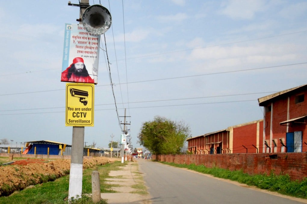 A placard bearing a picture of spiritual leader Ashutosh Maharaj outside his ashram in Nurmahal, on the outskirts of Jalandhar in Punjab state. Photo: AFP