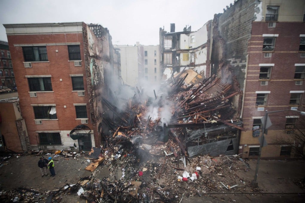 New York City firefighters work at the site of a building explosion and collapse in the Harlem section of New York. Photo: Reuters