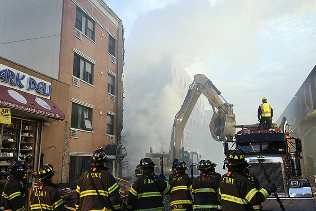 Firefighters at the site of the deadly building explosion and collapse in the Harlem section of New York. Photo: Reuters