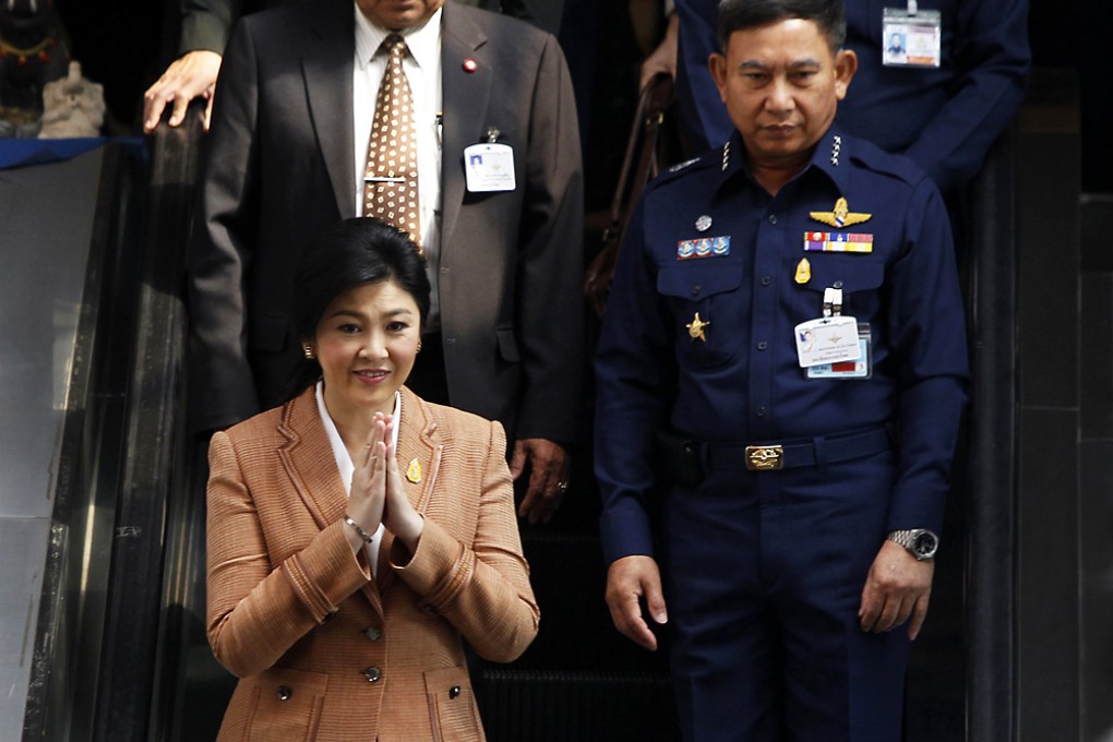 Thailand's Prime Minister Yingluck Shinawatra leaves the Royal Thai Air Force Headquarters in Bangkok. Photo: Reuters