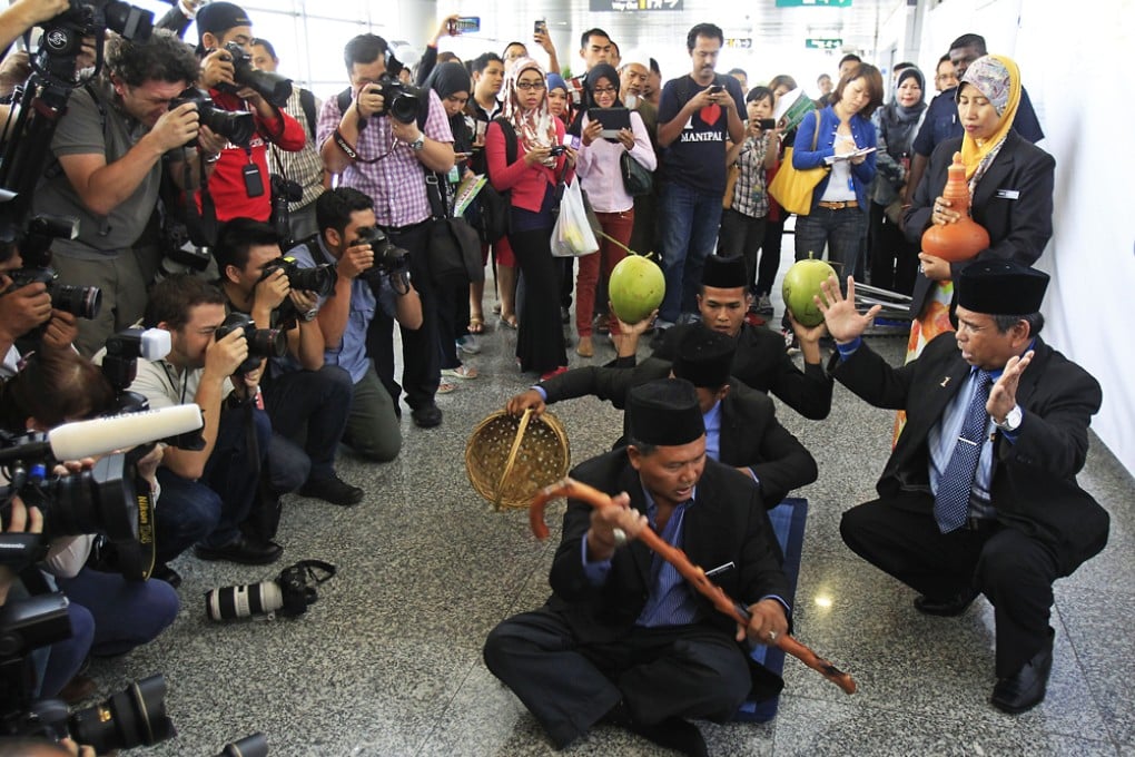 Ibrahim Mat Zin, also known as the Raja Bomoh Sedunia Nujum VIP, used spiritual methods and prayers at the Kuala Lumpur International Airport to help locate the missing plane. Photo: Reuters