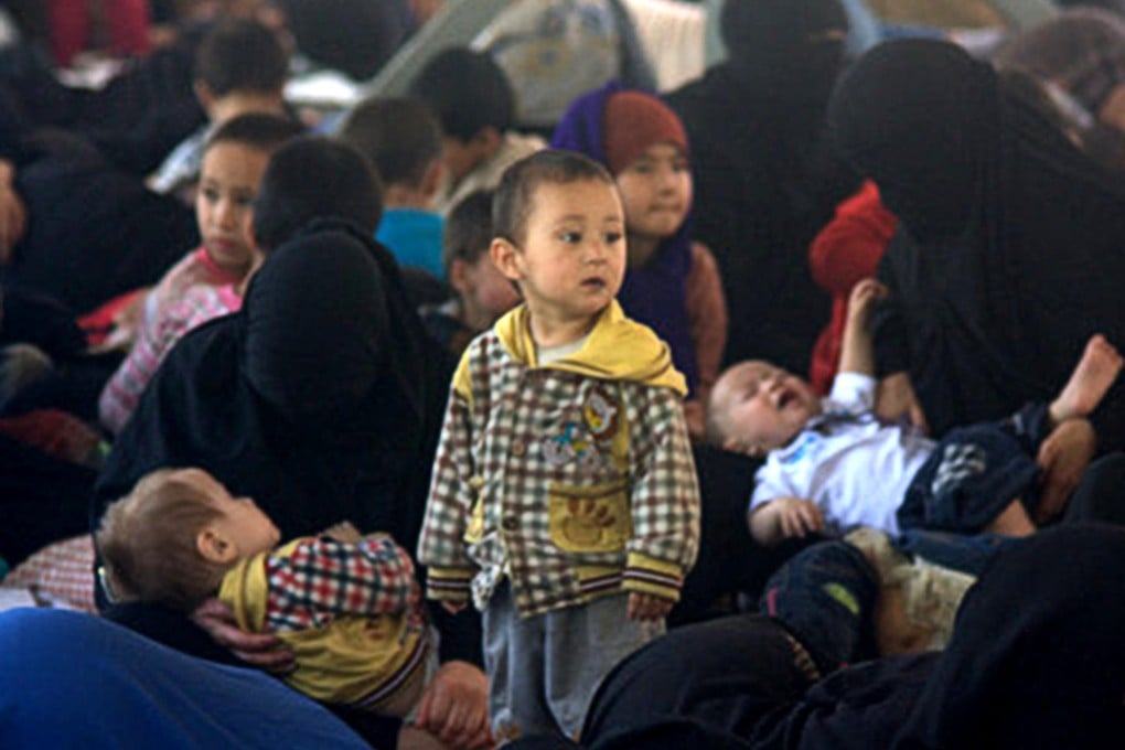 Refugees, believed to be Uygurs, herded into a camp in Songkhla province, southern Thailand. They include many children and a pregnant woman. Photo: Phuketwan