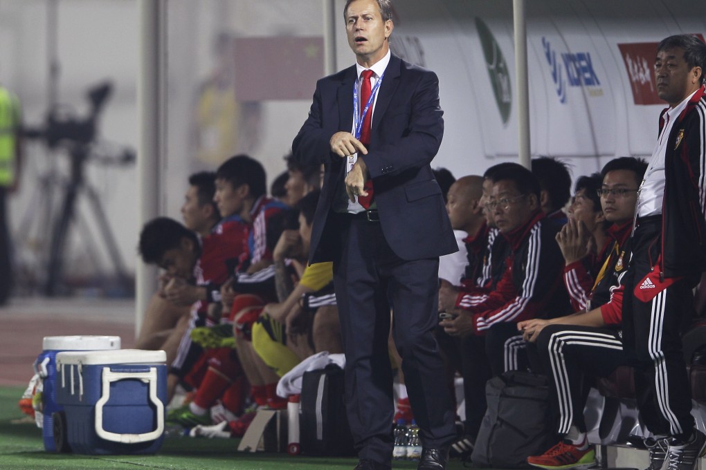 China coach Alain Perrin anxiously checks extra time at the end of their Asian Cup qualifying match against Iraq in Sharjah, United Arab Emirates. Photo: AP