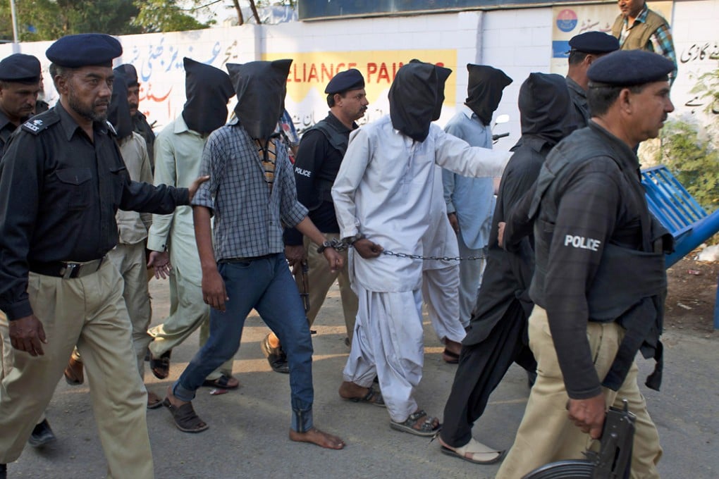 Police escort crime suspects arrested in an operation in Karachi at the weekend. Forty-four officers have been killed this year. Photo: AP