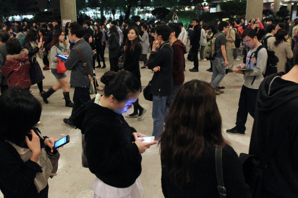 Pedestrians busy on their smartphones in Causeway Bay.