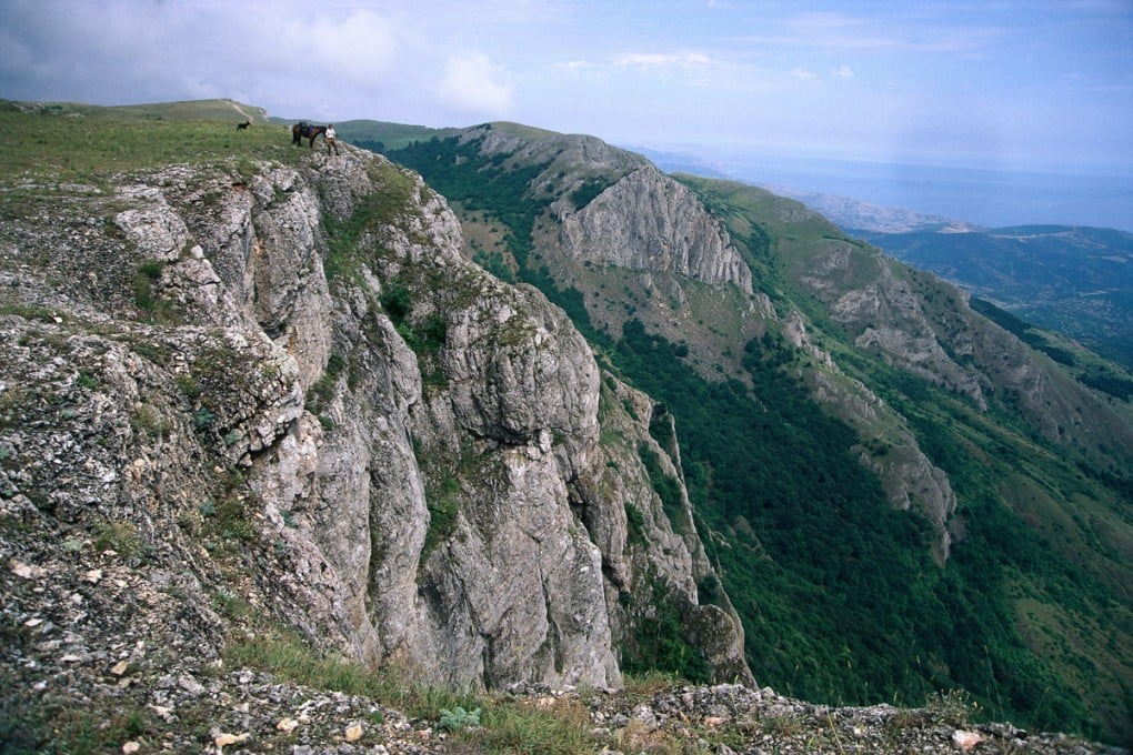 Tim Cope, along with his horse, Taskonir, and trusty Kazakh dog, Tigon, stand on the edge of the Karabi Jayla, in Crimea, overlooking the Black Sea. Photos: Tim Cope; Reuters; EPA