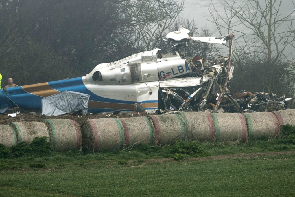 Police and experts seen inspecting the wreckage of the helicopter at the accident site in Norfolk. Photo: EPA