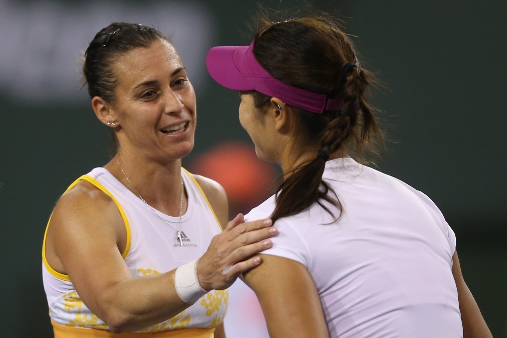 Flavia Pennetta consoles Li Na following their semi-final match in Indian Wells. Photo: AFP