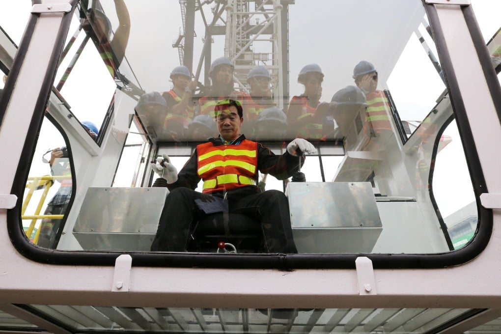 A crane operator shows off an updated operating cabin at Hongkong International Terminals' Kwai Fong port. Photo: K.Y. Cheng