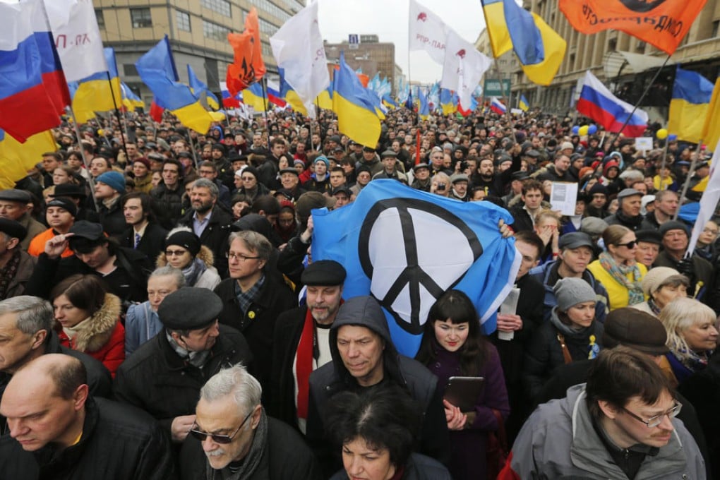 People take part in an anti-war rally in Moscow as Russia vetoes the UN resolution on the referendum on Crimea. Photo: Reuters