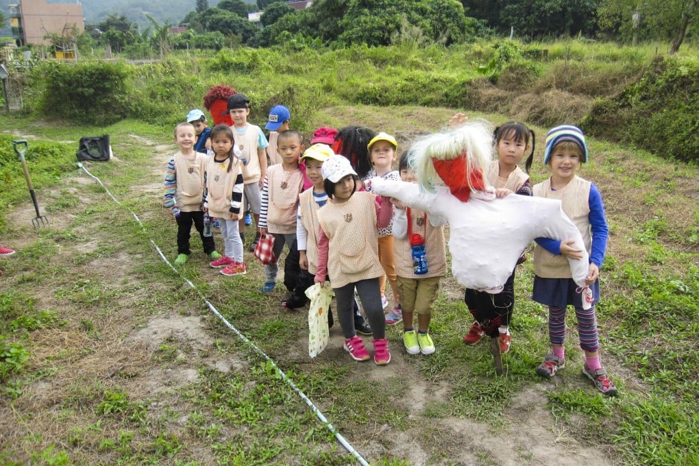 Making a scarecrow to protect seed beds is part of the hands-on fun for children at Dragontail Farm near Mui Wo.