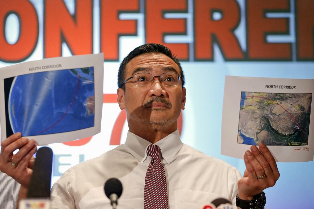 Acting Transport Minister Hishammuddin Hussein shows two maps with the search corridors for the missing Malaysia Airlines jet. The areas stretch from Kazakhstan to the southern Indian Ocean. Photo: Reuters