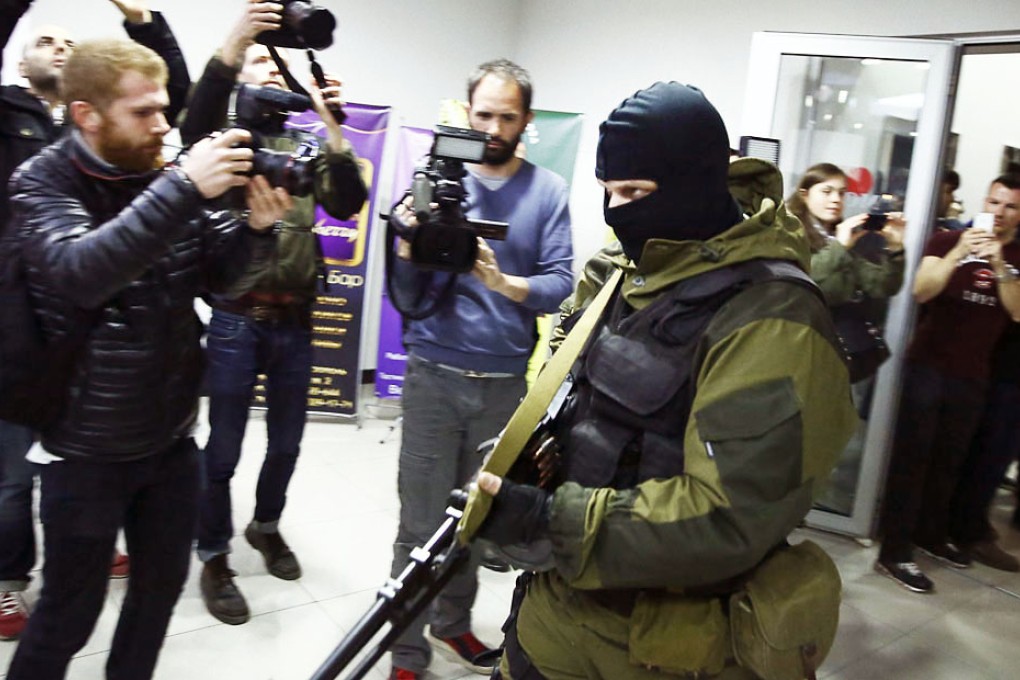 Gunmen storm into a hotel in the Crimean regional capital Simferopol on Saturday just ahead of a tense referendum on the Black Sea peninsula to leave Ukraine and join Russia. About 30 armed men arrived at the Hotel Moscow, most of them wearing balaclavas and wielding Kalashnikov assault rifles. At the hotel, where many journalists are staying, one gunman told reporters: "We already smashed one camera, do you want us to break another one?" Photo: Reuters