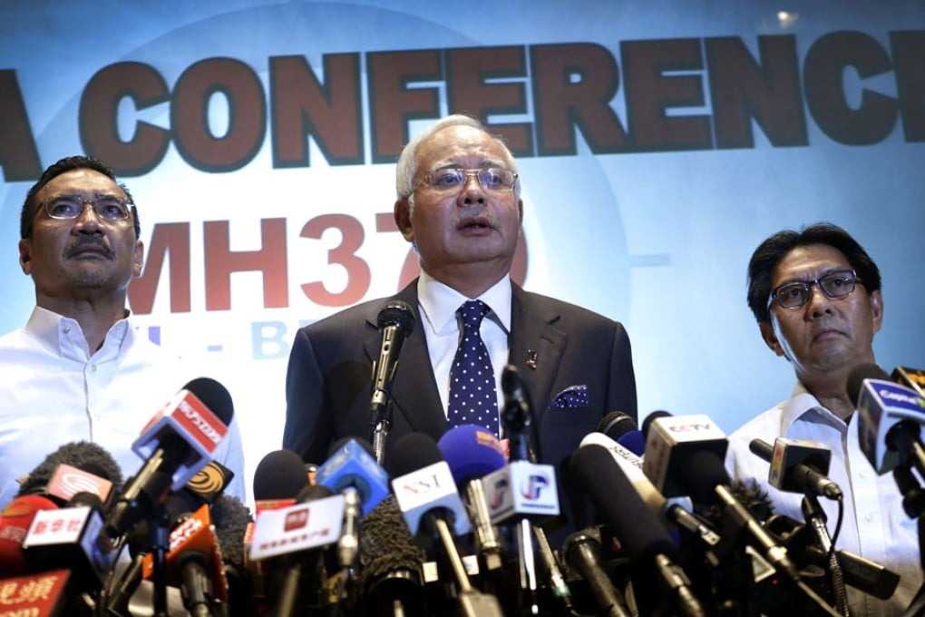 Malaysian Prime Minister Najib Razak (center) said that investigators believe the missing Malaysian airliner's communications were deliberately disabled, that it turned back from its flight to Beijing and flew for more than seven hours.