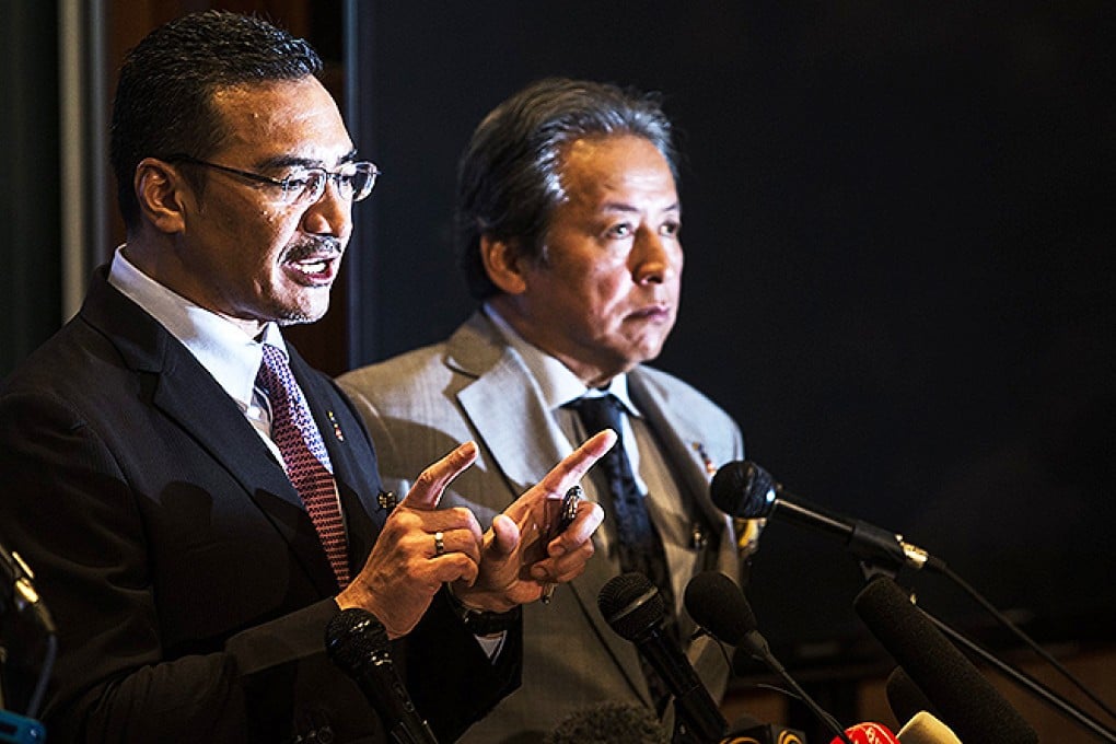 Malaysian Defence Minister and acting Transport Minister Hishamuddin Hussin (left) and Foreign Miinister  Anifah Aman speak to the media on Tuesday. Photo: EPA