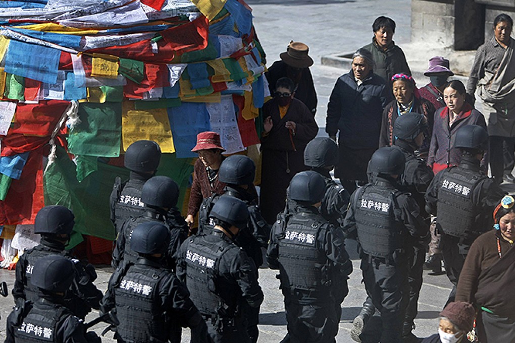 Special Weapons and Tactics police patrol outside the Jokhang monastery in Lhasa. Photo: Reuters