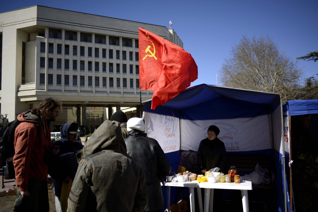 A Soviet era red flag in front of the Crimea's parliament in Simferopol, Crimea. Photo: EPA