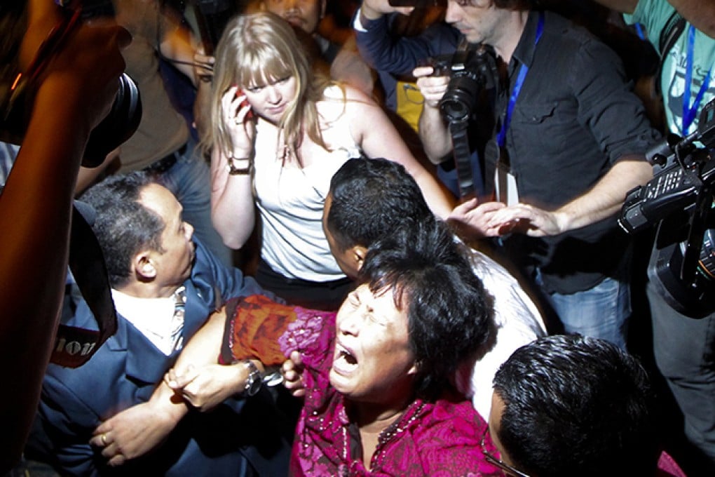 A relative of a passenger onboard the missing Malaysia Airlines Flight MH370 screams as she is removed from the media conference at a hotel in Kuala Lumpur. Photo: Reuters