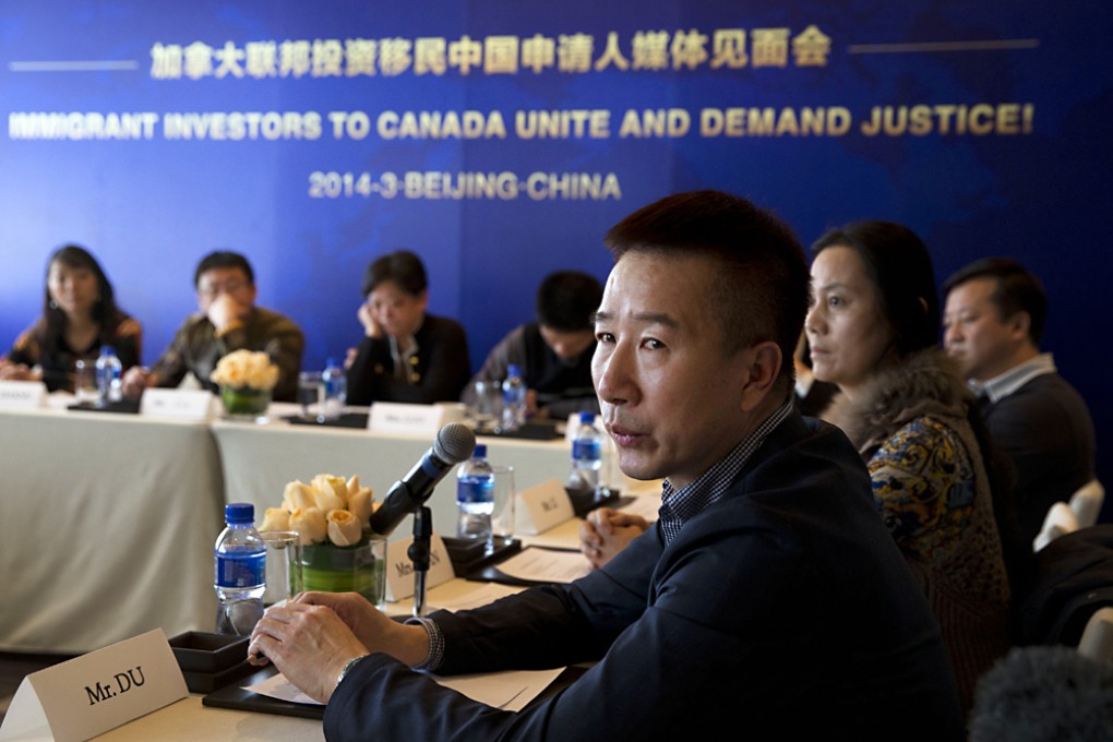 Chinese Investor applicant Du Jun talks about his faith next to other investors during a press conference in Beijing, China. Chinese millionaires on Tuesday made a plea to the Canadian government to ditch its plans to end its backlogged investor immigrant program and eliminate thousands of applications from Chinese nationals. Photo: AP