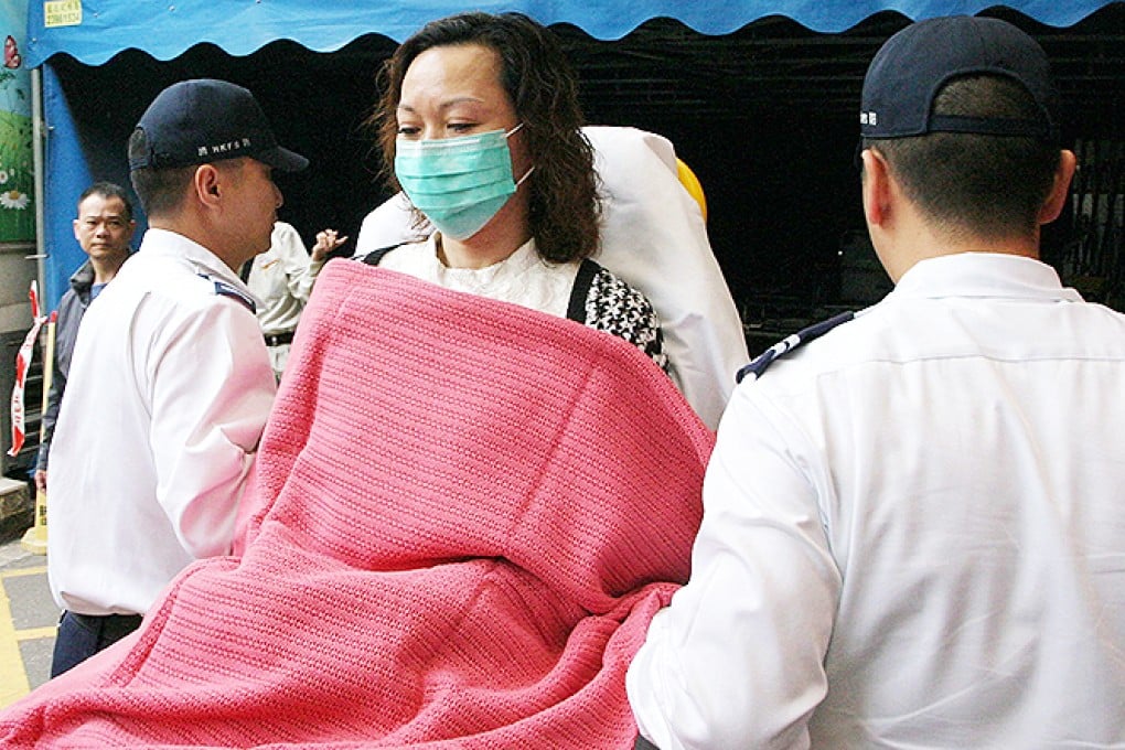 Lei Iun-han, 46, the director and vice president of Hong Kong Morning News Media Group, is sent to hospital after being attacked by four masked men in Tsim Sha Tsui. Photo: SCMP Pictures