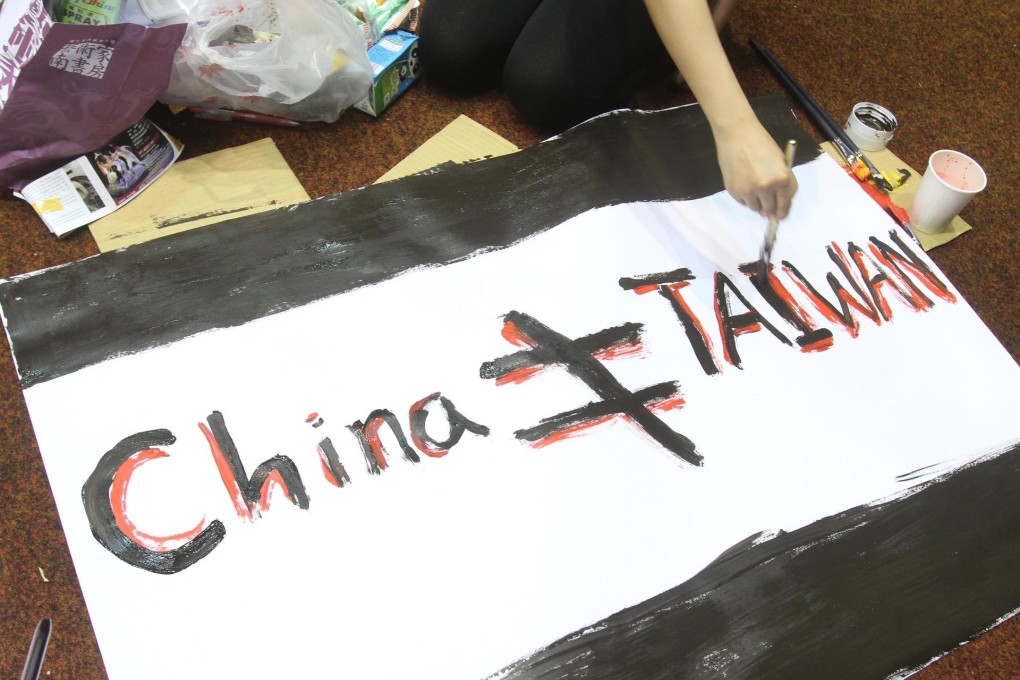 A slogan reading "China Is Not Equal to Taiwan". Photo: AP