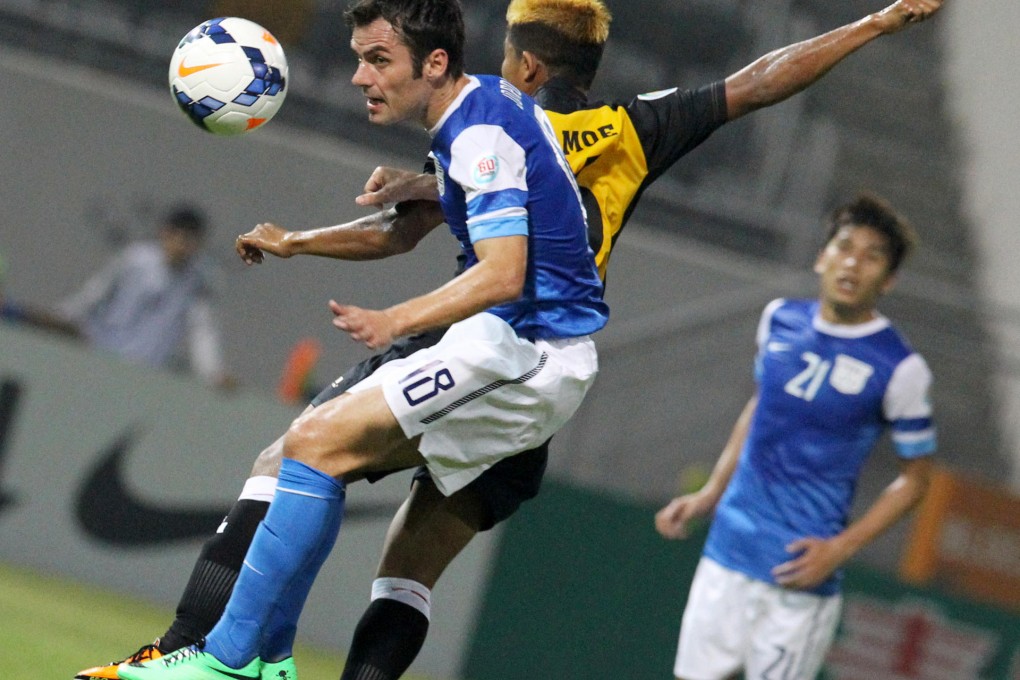 Kitchee striker Jorge Tarres (left) wins a battle for the ball with Nay Pyi Taw's Moe Tin Zaw at Mong Kok Stadium. Photo: Edward Wong