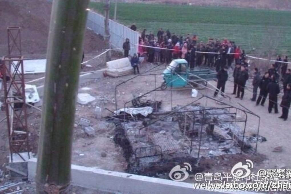 Villagers gathered near the debris of the tent that was burned down on Friday morning. Photo: weibo screenshot