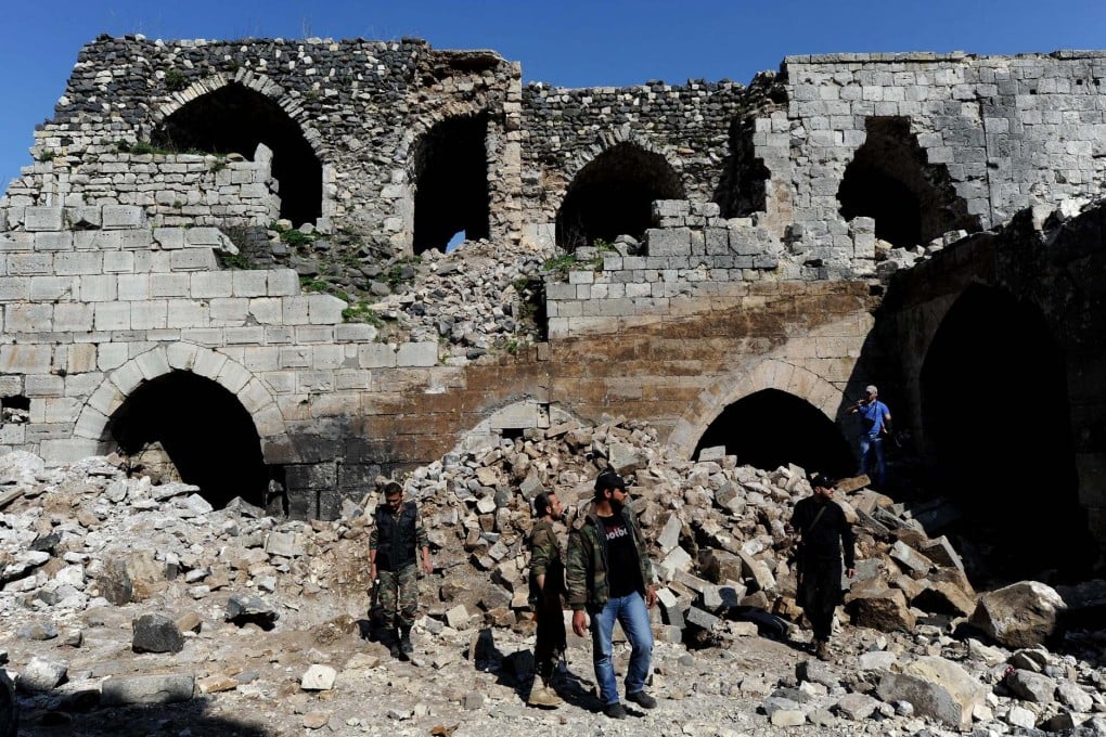 Syrian government troops in the ruins of Krak des Chevaliers, the World Heritage-listed Crusader castle recaptured from rebels after fighting last week. Photo: Xinhua