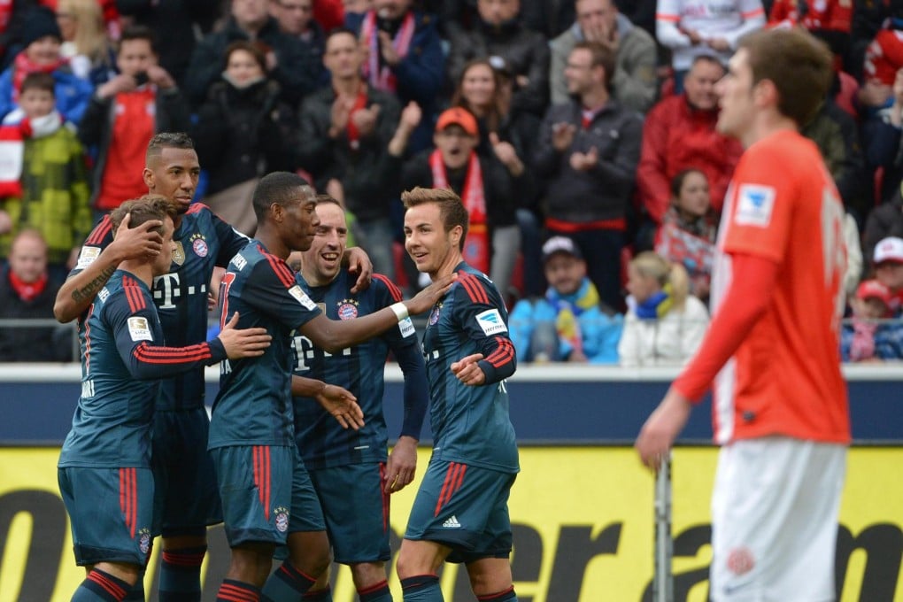 Bayern Munich players celebrate Mario Goetze's goal in their 2-0 victory over Mainz for their 18th straight Bundesliga win. Photo: EPA