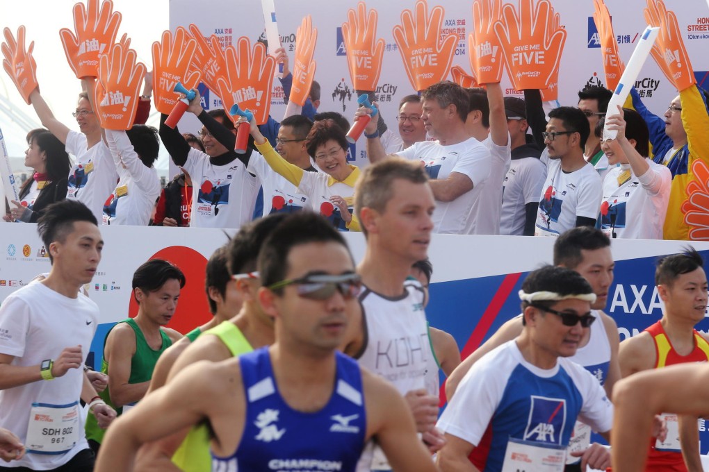 Chief Secretary Carrie Lam (centre in the background) attends the start of the 10 kilometre AXA Hong Kong Streetathon at the Kai Tak Cruise Terminal. Photo: K. Y. Cheng