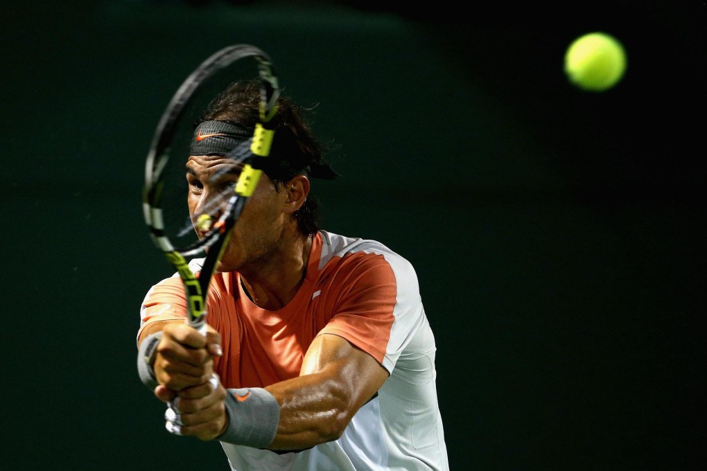 Rafael Nadal hits a backhand shot against Lleyton Hewitt. Photo: AFP