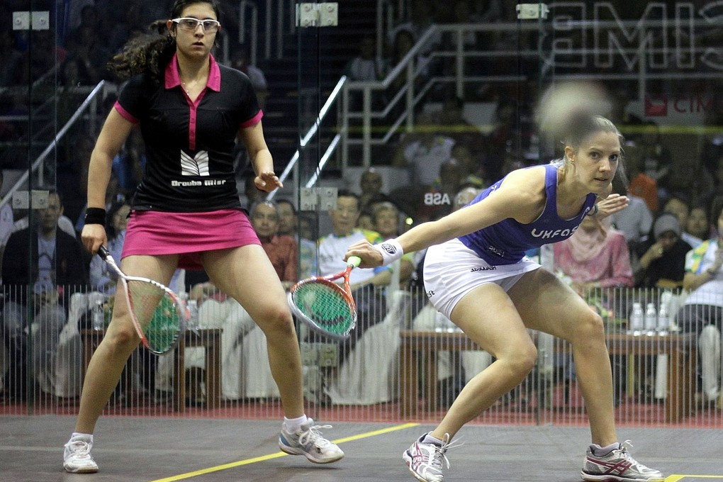 England's Laura Massaro (right) returns a shot against Nour El Sherbini of Egypt in their squash final at the Spice Arena in Georgetown. Massaro won 11-7, 6-11, 11-9, 5-11, 11-9. Photo: AFP