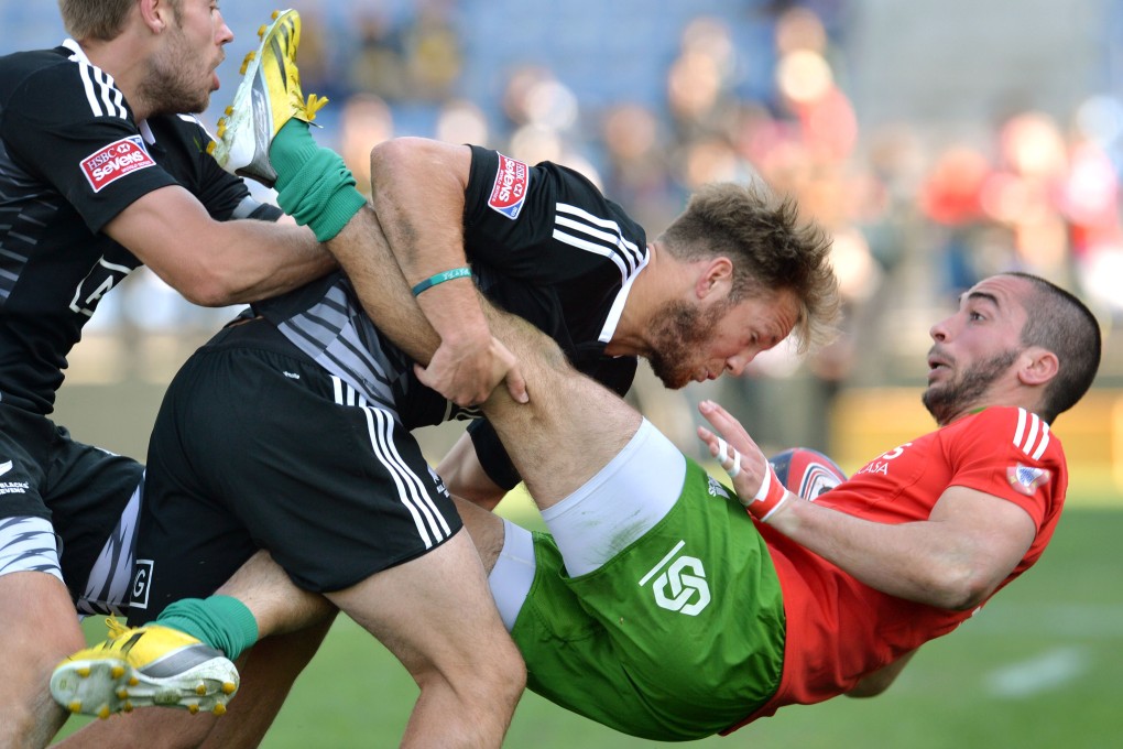 New Zealand's Marty Mackenzie tackles Portugal's Tomas Noronha during their Tokyo Sevens match. New Zealand won 40-7. Photo: AFP