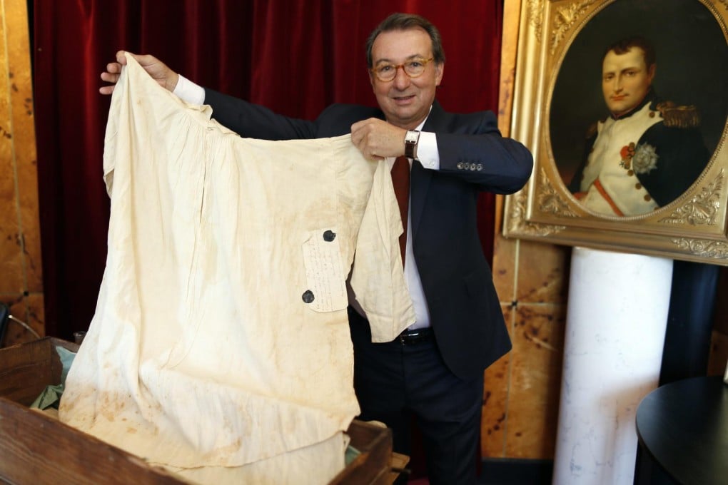 Auctioneer Jean-Pierre Osenat with the sweat-stained nightshirt that had been worn by Napoleon on his deathbed in 1821. Photo:Reuters