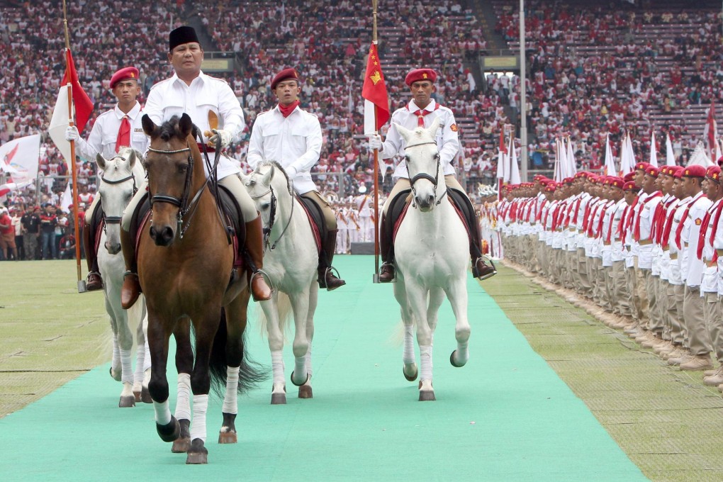 Prabowo Subianto inspects party members during a rally in Jakarta at the weekend. He wants to boost agriculture spending. Photo: EPA