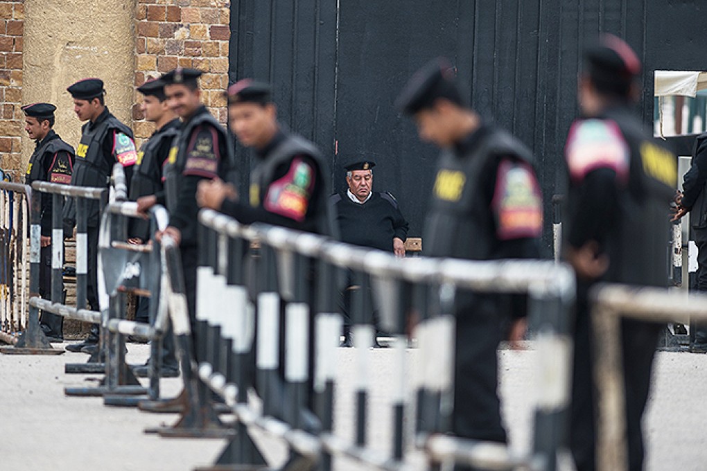 Policemen stand guard outside Cairo Police Academy where former Egyptian president Mohammed Mursi and other defendants await trial. Photo: Xinhua