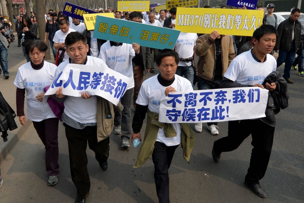 Chinese relatives of passengers on missing Malaysia Airlines flight MH370 march to protest outside the Malaysian embassy in Beijing. Photo: AFP