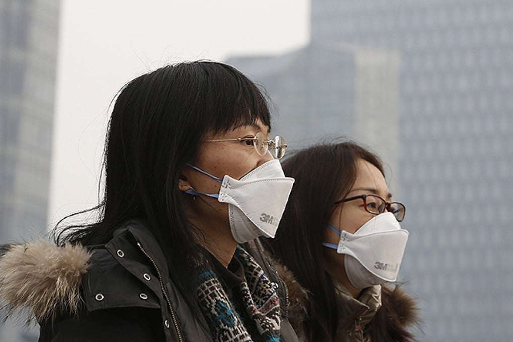 Women wear face masks walking in Shanghai during a spell of high air pollution. Photo: Reuters