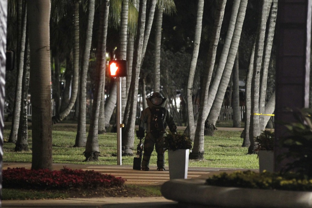 A Miami-Dade Metro Police bomb squad member stands near the main entrance to the Sony Open tournament. Police briefly stopped vehicle and foot traffic in the immediate area outside the venue. Photo: AP